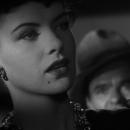 Faux femme fatale: Kansas (Ella Raines) entrances the drummer (Elisha Cook, Jr.) in the jazz dive