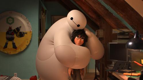 Smothering him with love: Hiro gets a suffocating squeeze from his new buddy Baymax