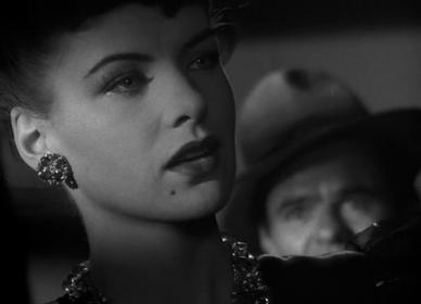 Faux femme fatale: Kansas (Ella Raines) entrances the drummer (Elisha Cook, Jr) in the jazz dive
