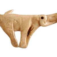 Spear thrower made from reindeer antler, sculpted as a mammoth. Found in the rock shelter of Montastruc, France, c. 13,000 to 14,000 years old. Copyright of The Trustees of the British Museum