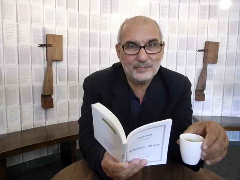 Alan Yentob with that copy of 'Robinson Crusoe'. It took as long to print as it took to make that espresso