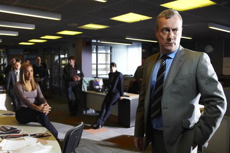 Banks (Stephen Tompkinson) thinks better of sharing a joke with his colleagues