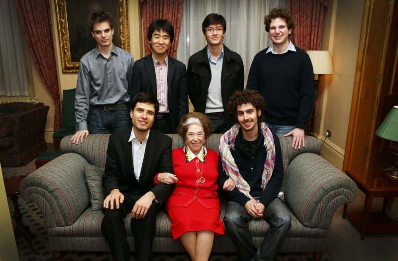 Dame Fanny Waterman surrounded by this year's finalists. Clockwise, from top left: Andrew Tyson, Jiayan Sun, Louis Schwizgebel, Jayson Gillham, Federico Colli, Andrejs Osokins