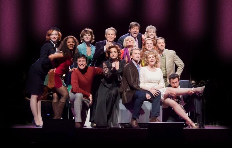 Two-time Tony-winner Patti LuPone, seated front and centre and surrounded by the cast of Company