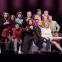 Two-time Tony-winner Patti LuPone, seated front and centre and surrounded by the cast of Company