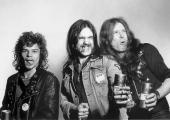 Unsure whether they were marketing themselves or a brand of beer in 1977, Motörhead further undermine the promotion with their choice of badges. Left to right: Phil Taylor, Lemmy, Eddie Clarke