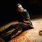 Downward dog: Greg Hicks' Richard is tethered wrist to toe with a jingling chain