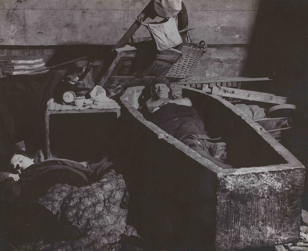 Bill Brandt, East End Crypt Shelter. Man Sleeping in a Coffin, 1940, gelatin silver print, Hyman Collection, London, © Bill Brandt/Bill Brandt Archive Ltd.