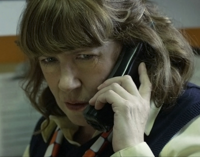 Sandra (Ann Dowd) receives a phone call in Compliance