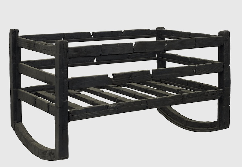 Carbonised wooden cradle