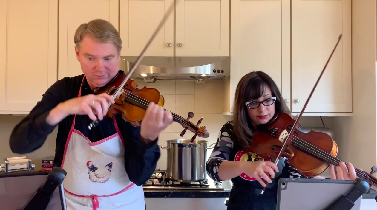 Rita Porfiris and Anton Miller playing in the kitchen