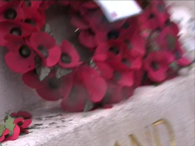 Cadet: Running at Preston (DVD installation): 'the artist runs in circles, filming the poppies, the grey uniforms, and gold lettering on the plinth' 